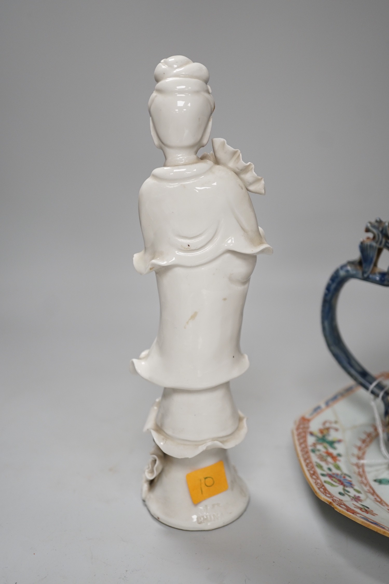 A Chinese figure of blanc de chine, a dragon tea bowl, a saucer, a large tankard, and another Chinese dish, tallest 23cm